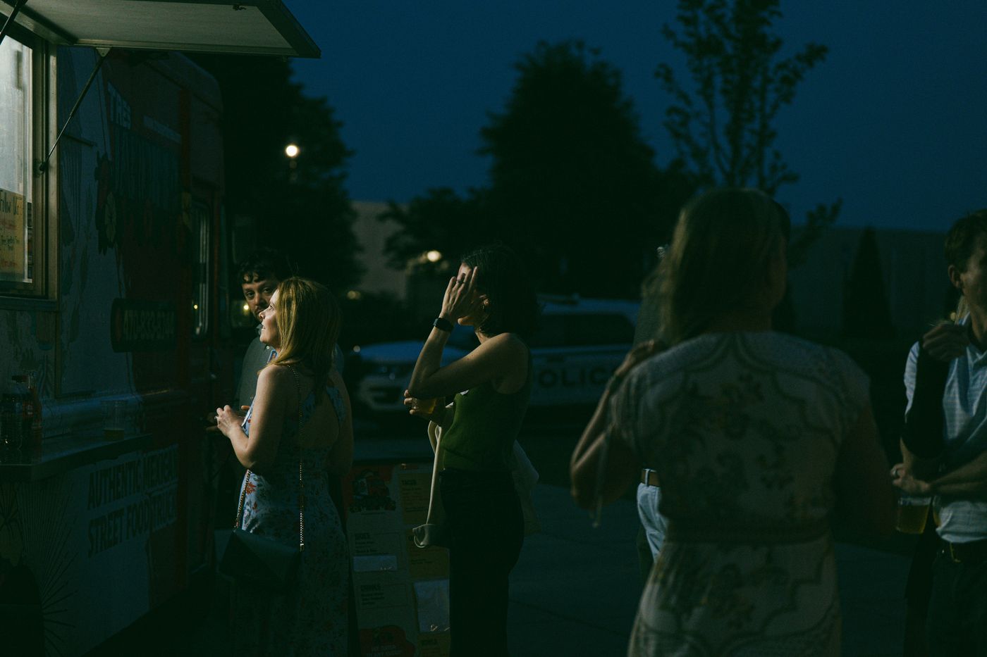 Gasten bij een foodtruck in de avond